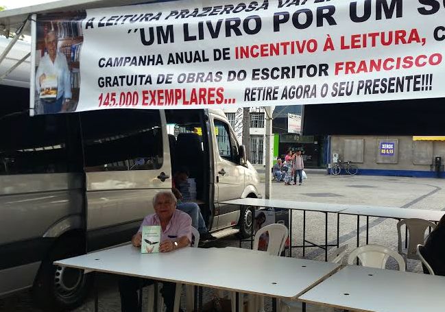 Escritor distribui livros em Campinas, cobrando um sorriso por exemplar